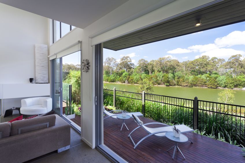 In the above room, streamlined roller blinds which “disappear” against plain walls provide practical solution without detracting from the view.